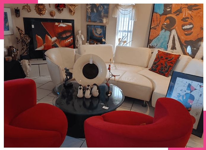 A living room with red chairs and white furniture